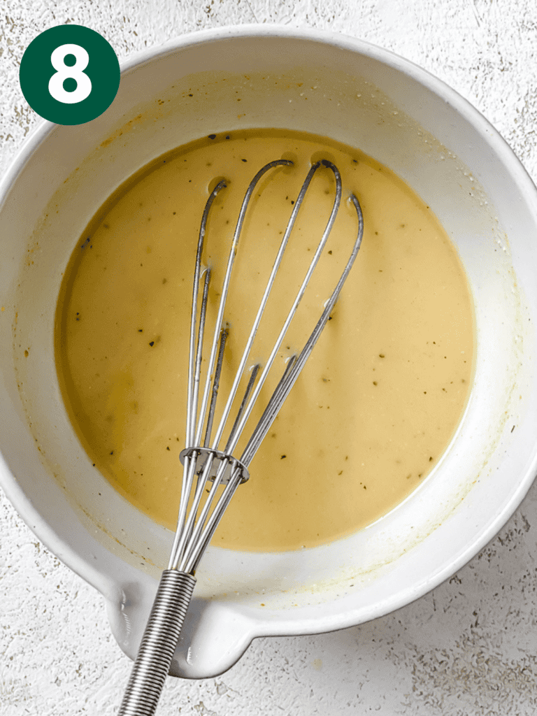 process s،t of whisking miso paste and vegetable broth in bowl