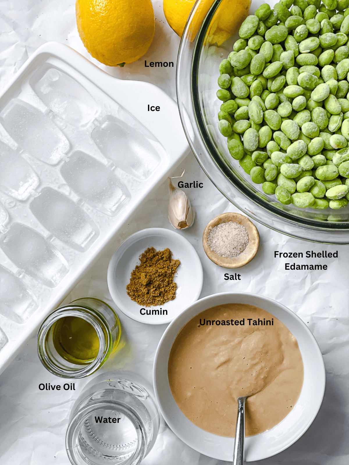 ingredients for Edamame Hummus measured out on a white surface
