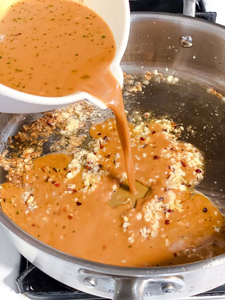 Sauce being poured into the pan