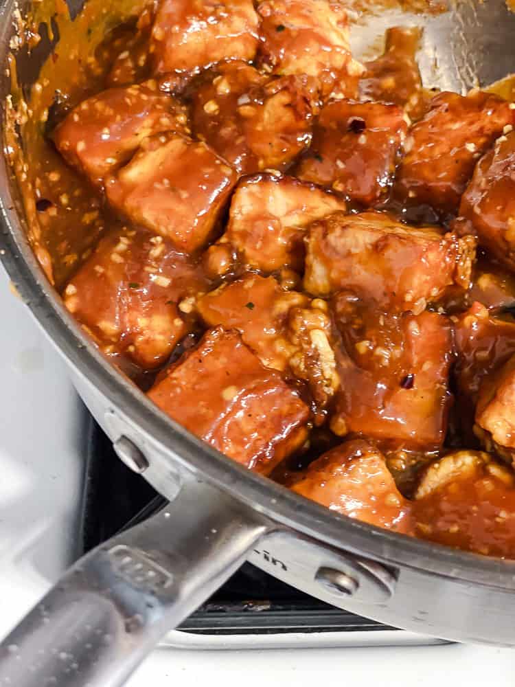 Tofu coated in the thickened sauce in the pan