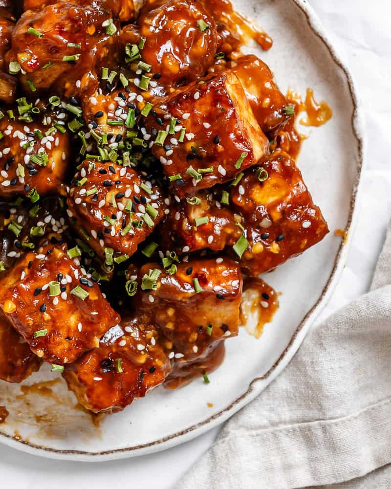 close up on General Tso's tofu on a white plate.