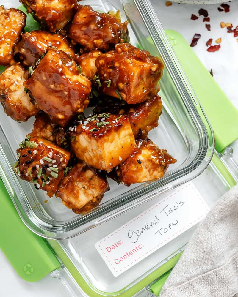 General Tso's tofu in a gl، storage container.