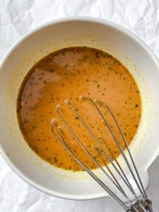 Sauce whisked together in a white bowl