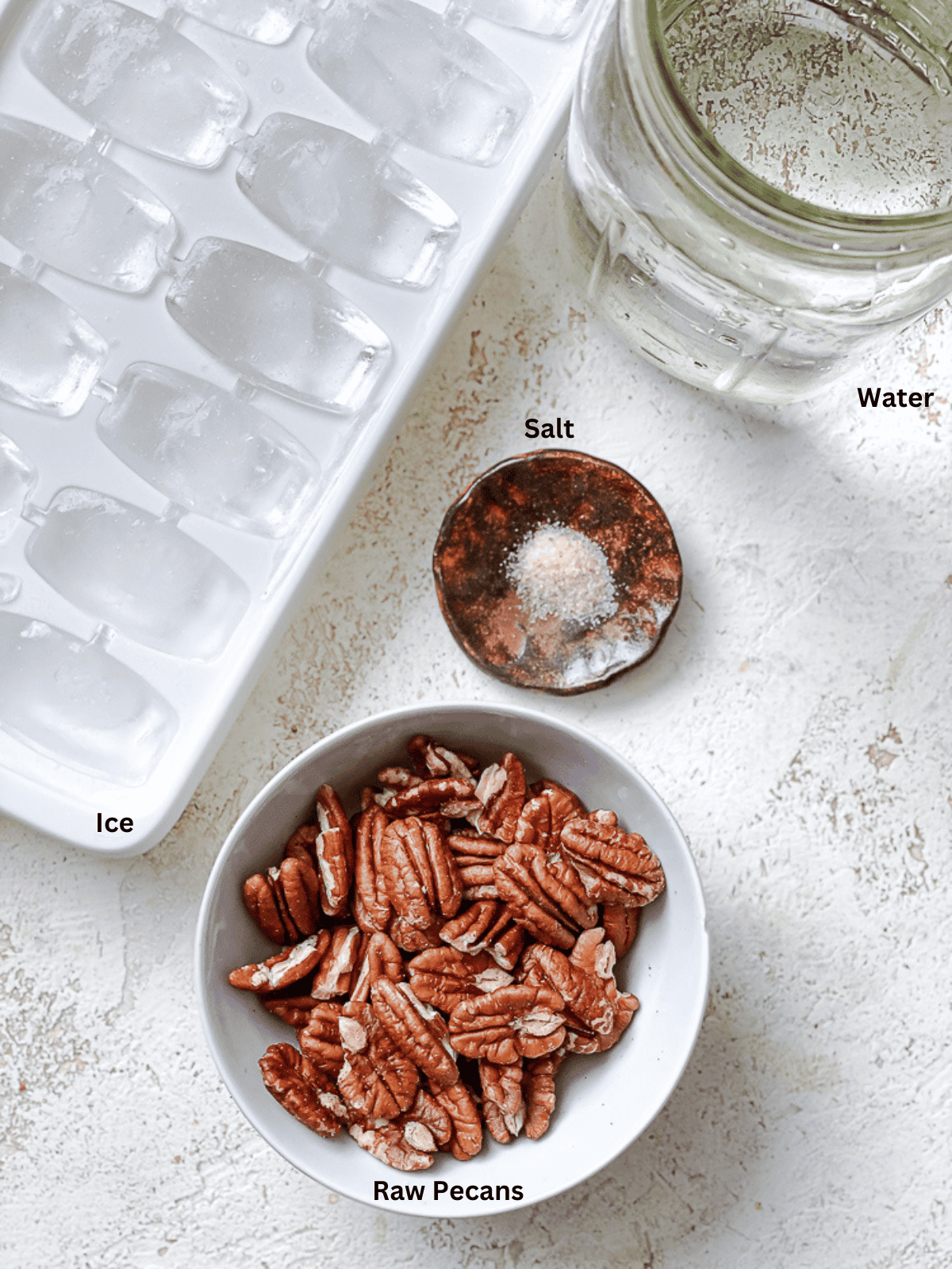 ingredients for pecan milk measured out on a white surface