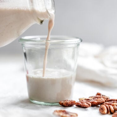 completed pecan milk being poured into cup