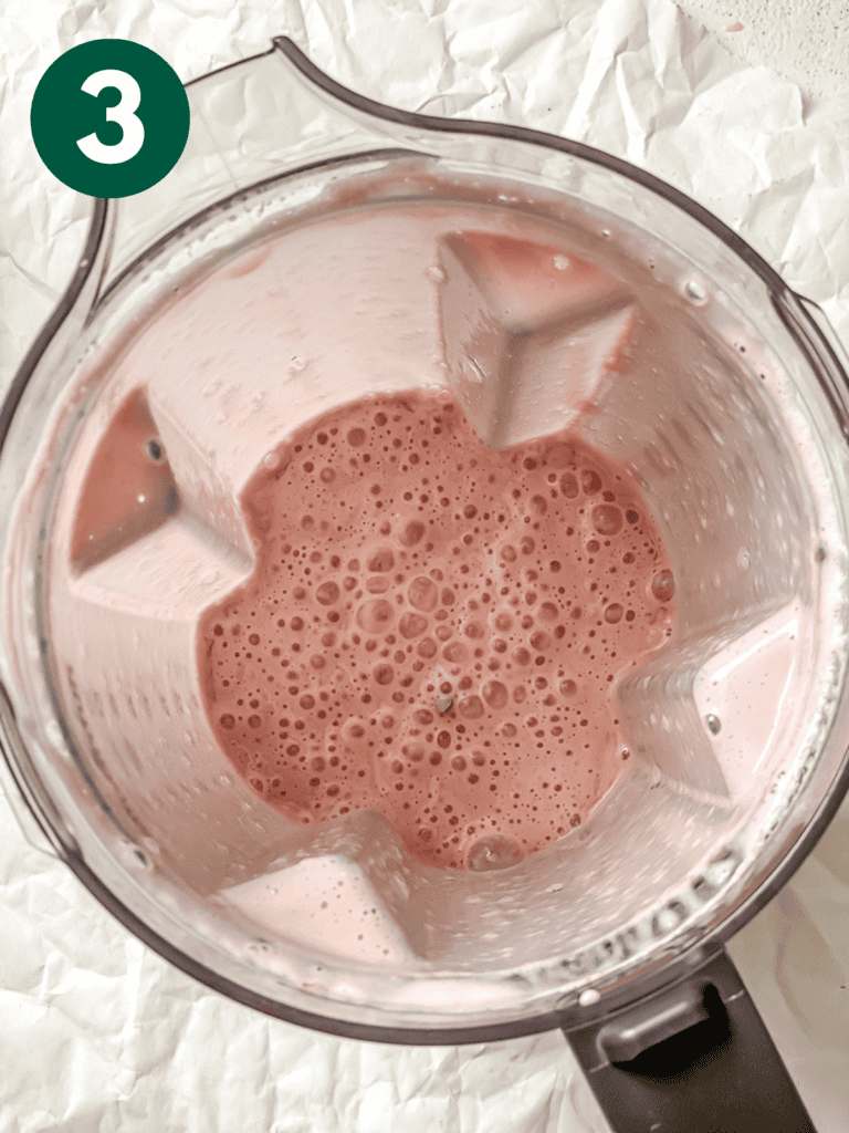 process shot showing post blended strawberry milk in blender