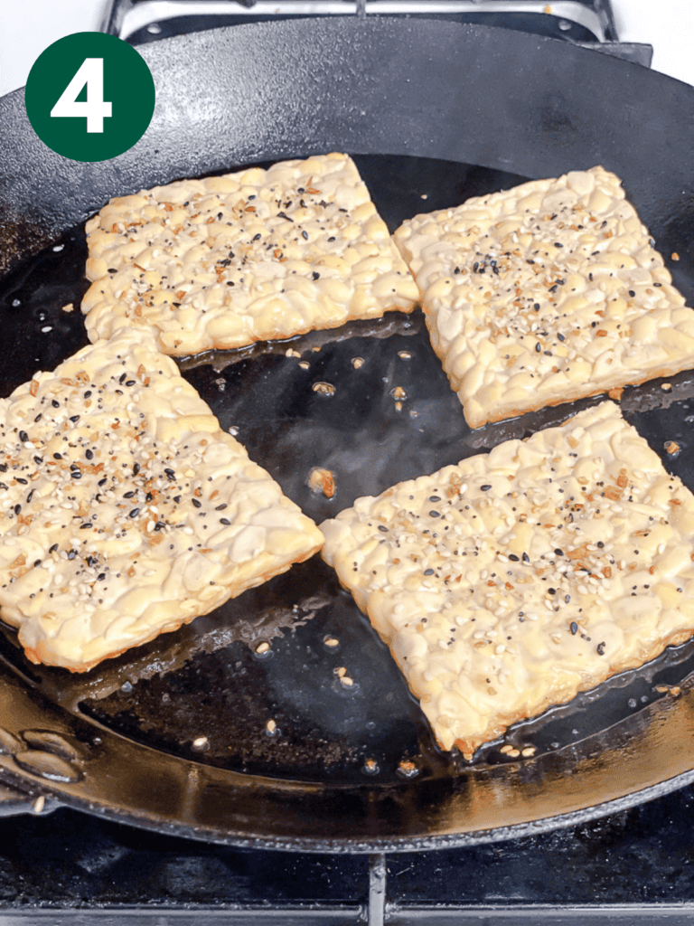 process s،t of cooking tempeh on a pan