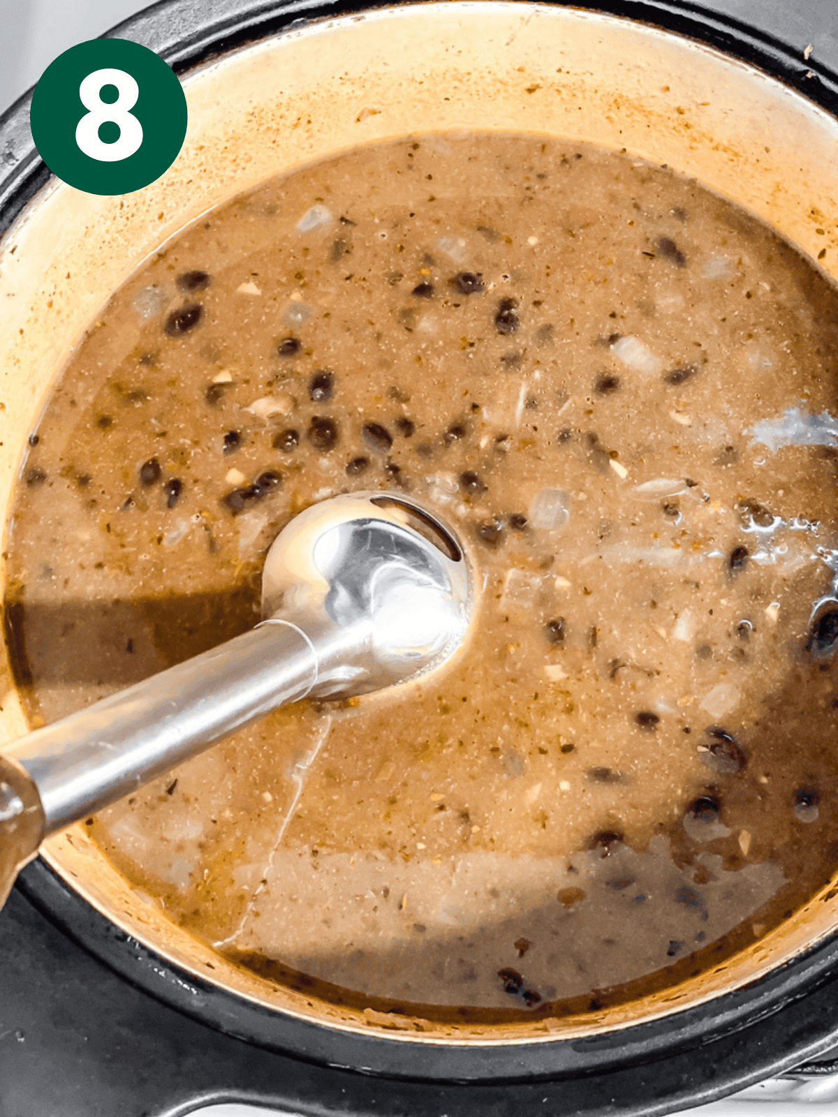 pureeing black bean soup with an immersion blender.