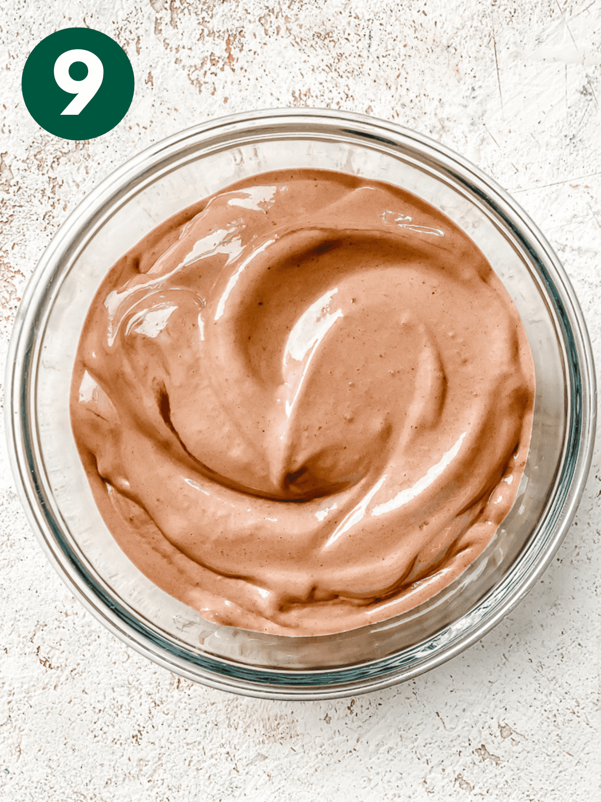 blended chocolate pb banana ice cream in a glass container.