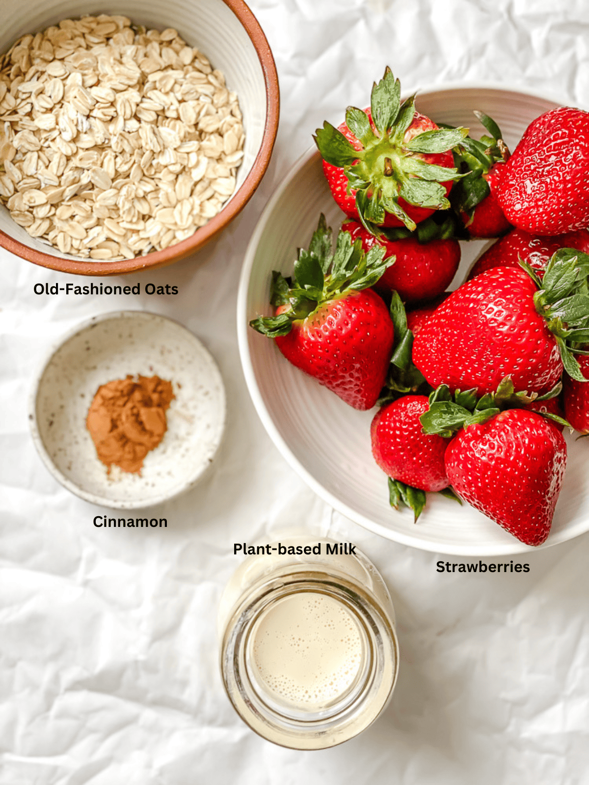 ingredients for Strawberry Oatmeal measured out on a white surface