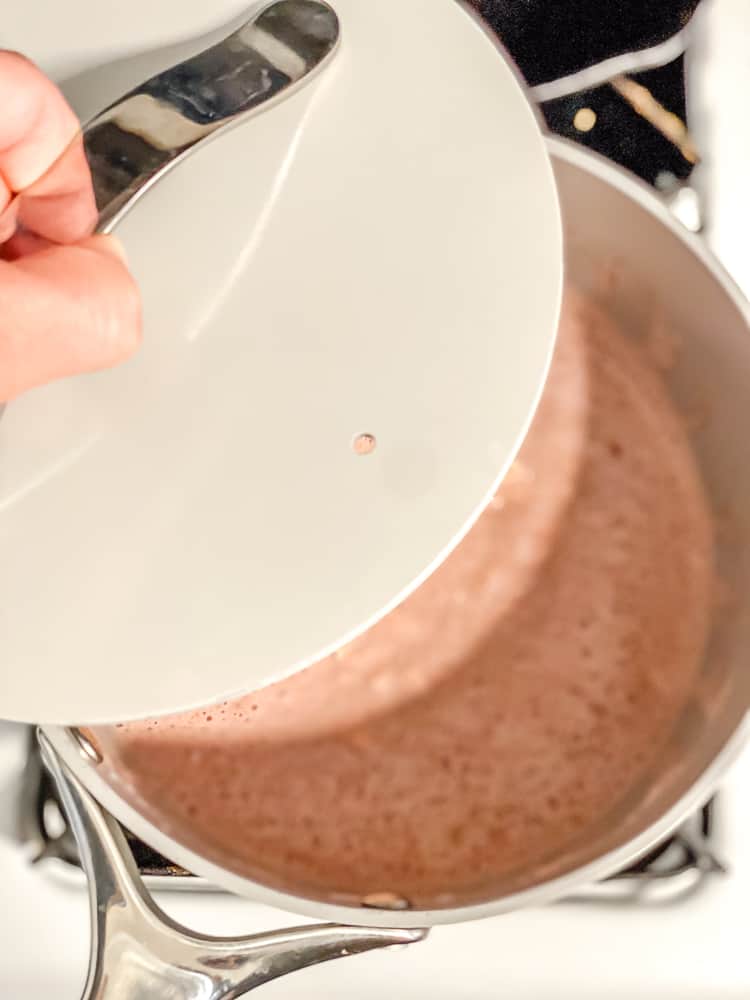 Process shot showing covering oatmeal with lid.