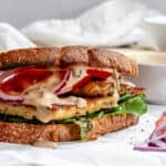 completed Tempeh Sandwich on a white surface