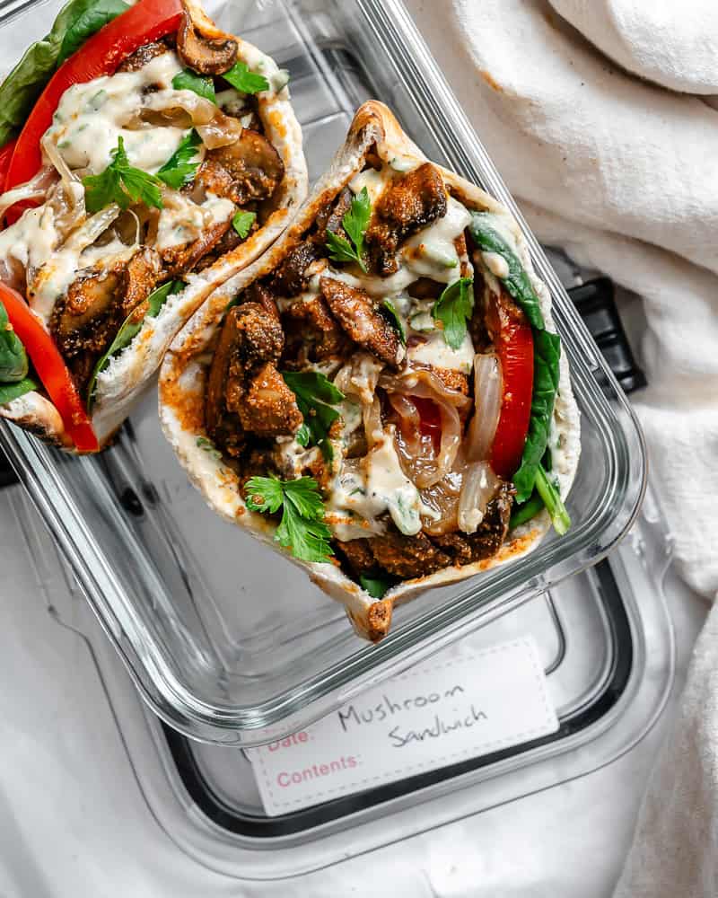 two open-faced mushroom sandwiches in a glass storage container.
