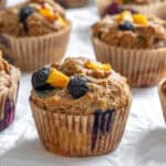 completed Blueberry Peach Muffins on white surface