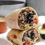 completed Quinoa Black Bean Burritos stacked on one another