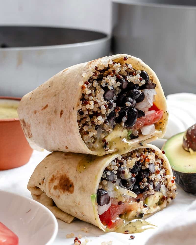 completed Quinoa Black Bean Burritos stacked on one another