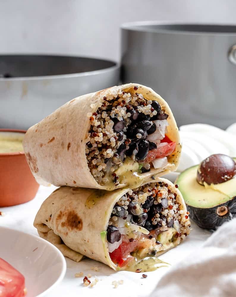 completed Quinoa Black Bean Burritos stacked on one another