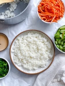 sushi rice and sushi bowl toppings in individual bowls.