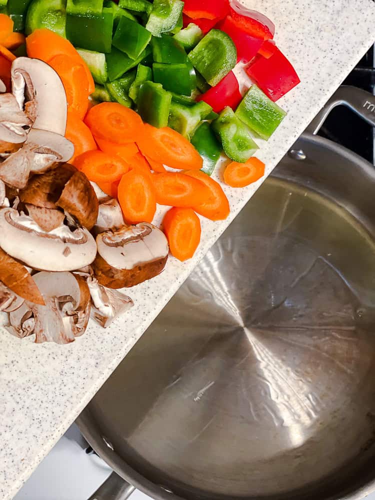 process shot showing adding veggies to pan
