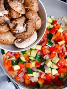 process shot showing adding mushrooms to pan