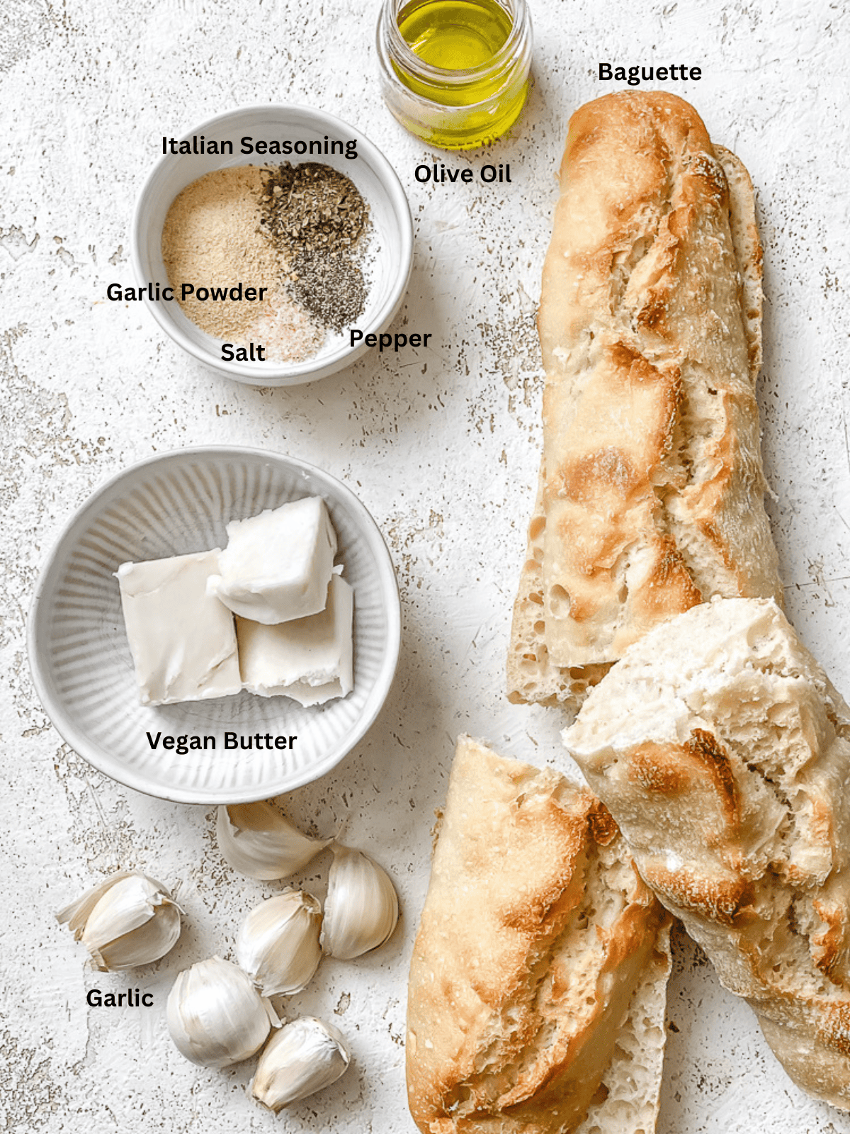 ingredients for Easy Vegan Garlic Bread on a white surface