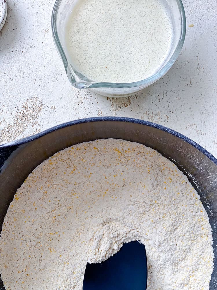 dry ingredients and wet ingredients for jalapeno cornbread in separate bowls.