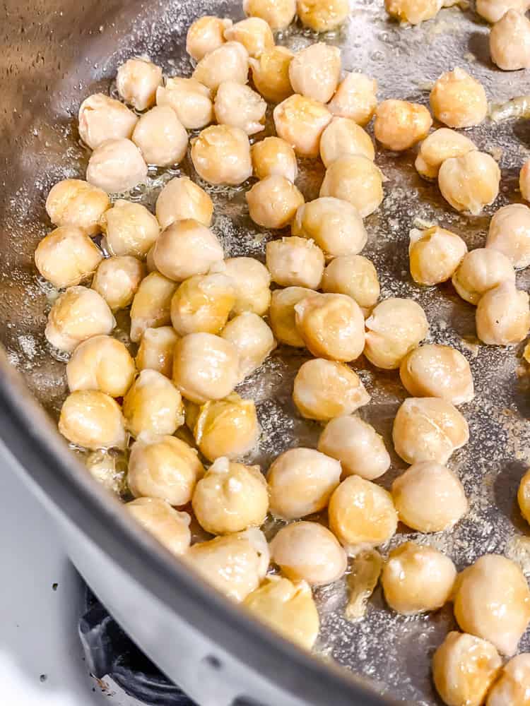 process shot showing chickpeas cookin in pan