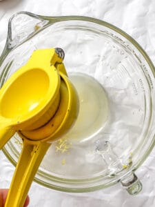 Juicing a fresh lemon for homemade popsicles.