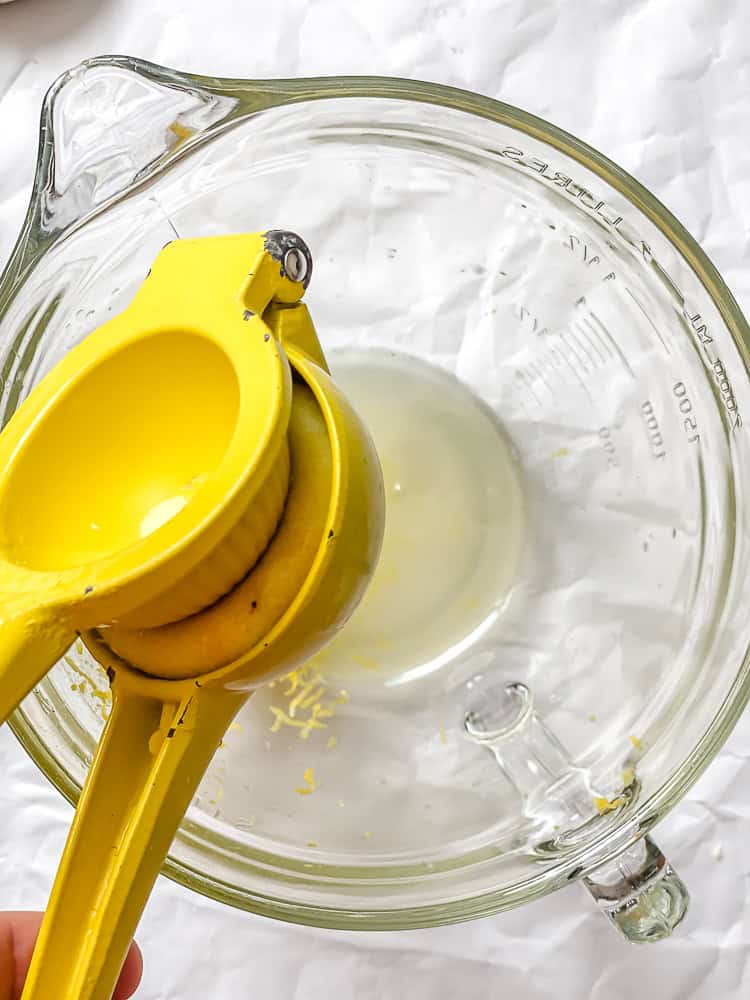 process shot showing juicing lemon into food processor
