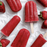 several completed Easy Strawberry Popsicles on a white surface