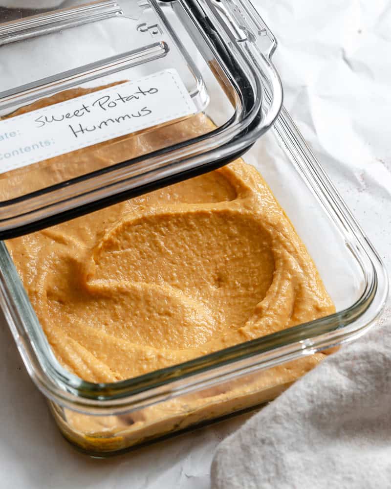 sweet potato hummus in a glass storage container.