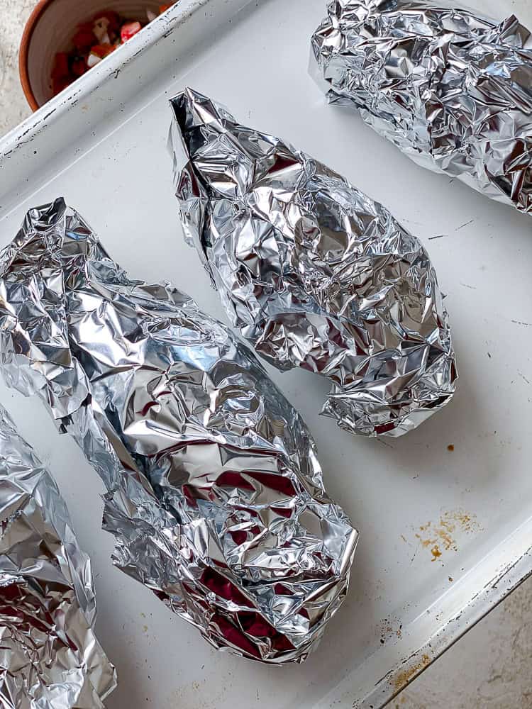 process shot showing sweet potatoes in aluminum foil