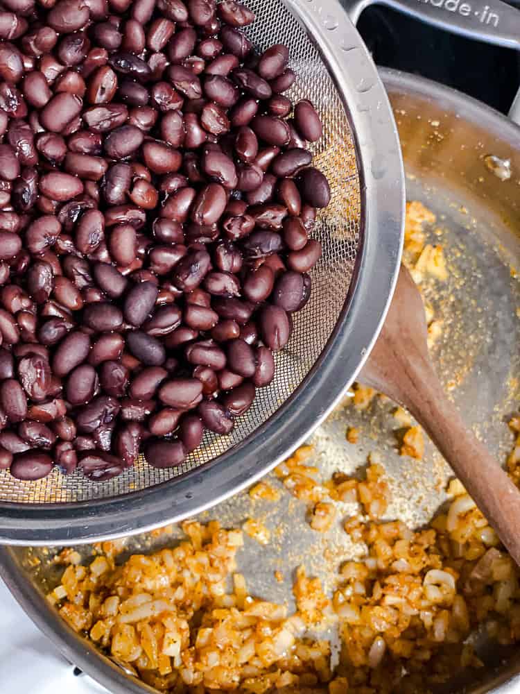 process shot showing adding beans to pan