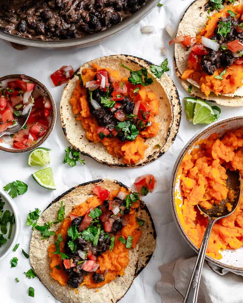 several completed Sweet Potato and Black Bean Tacos on a white surface