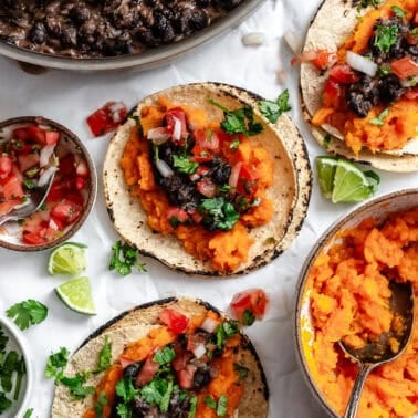 several completed Sweet Potato and Black Bean Tacos on a white surface