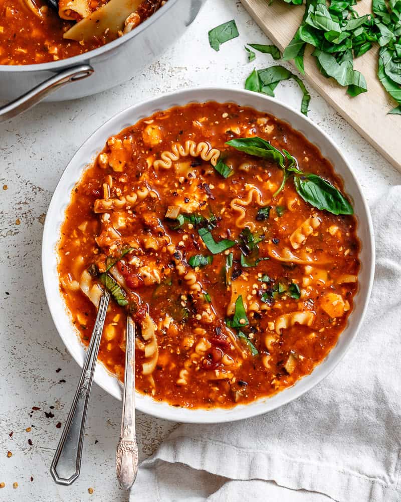 vegan lasagna soup in a white bowl.