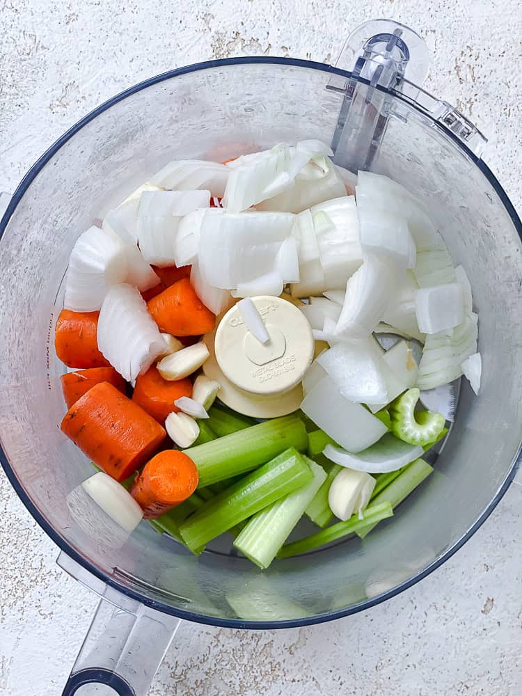 onions, carrots, and celery in a food processor.