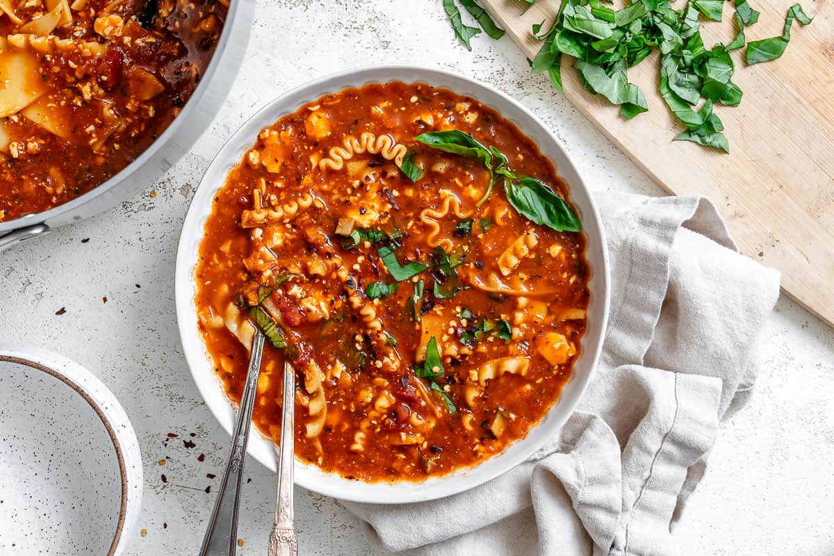 vegan lasagna soup in a white bowl.