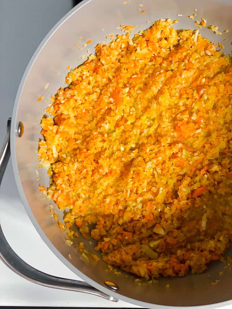 cooking diced veggies in a large pot.