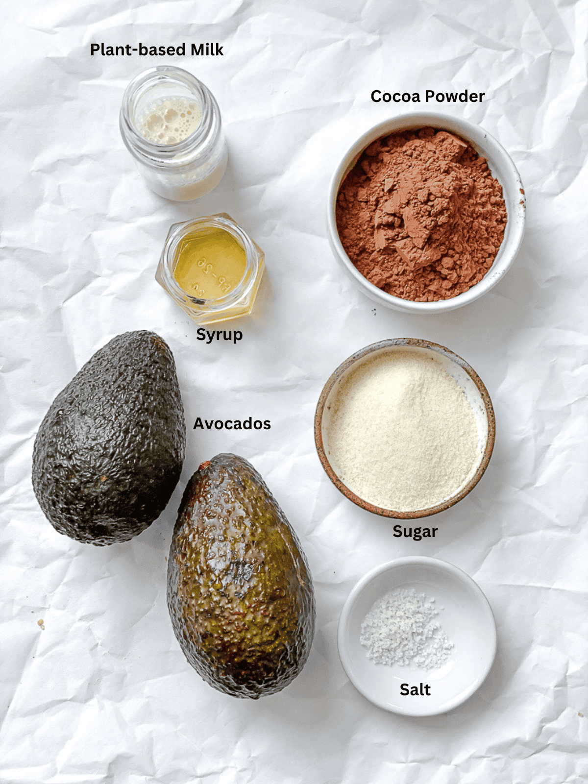 ingredients for avocado mousse in individual bowls with labels.