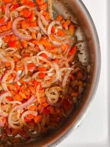 process shot showing veggies cooking in pan