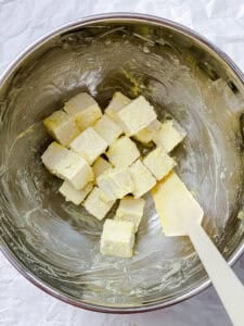 process shot showing tofu being mixed with cornstarch in bowl