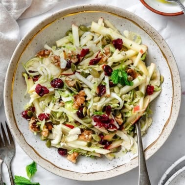 a Shaved Brussels Sprouts Salad in a bowl with a fork.