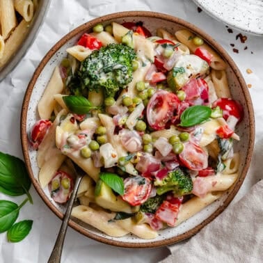 vegan pasta primavera in a white bowl.
