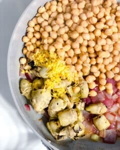 process shot of veggies cooking in pan