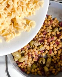 process shot of adding pasta to pan