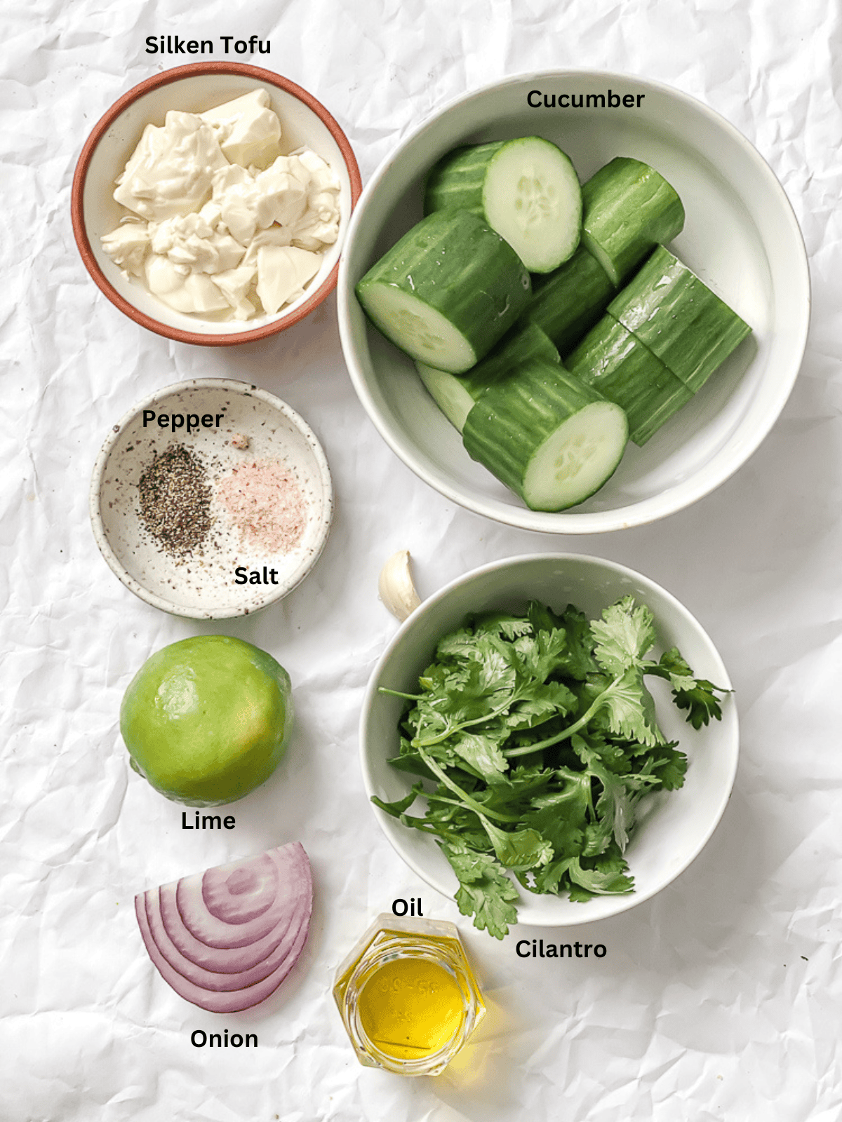 ingredients for Cucumber Gazpacho [Cold Cucumber Soup] measured out on a white surface