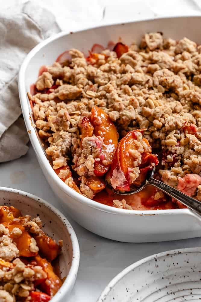 completed Easy Nectarine Crisp in baking dish and small plate