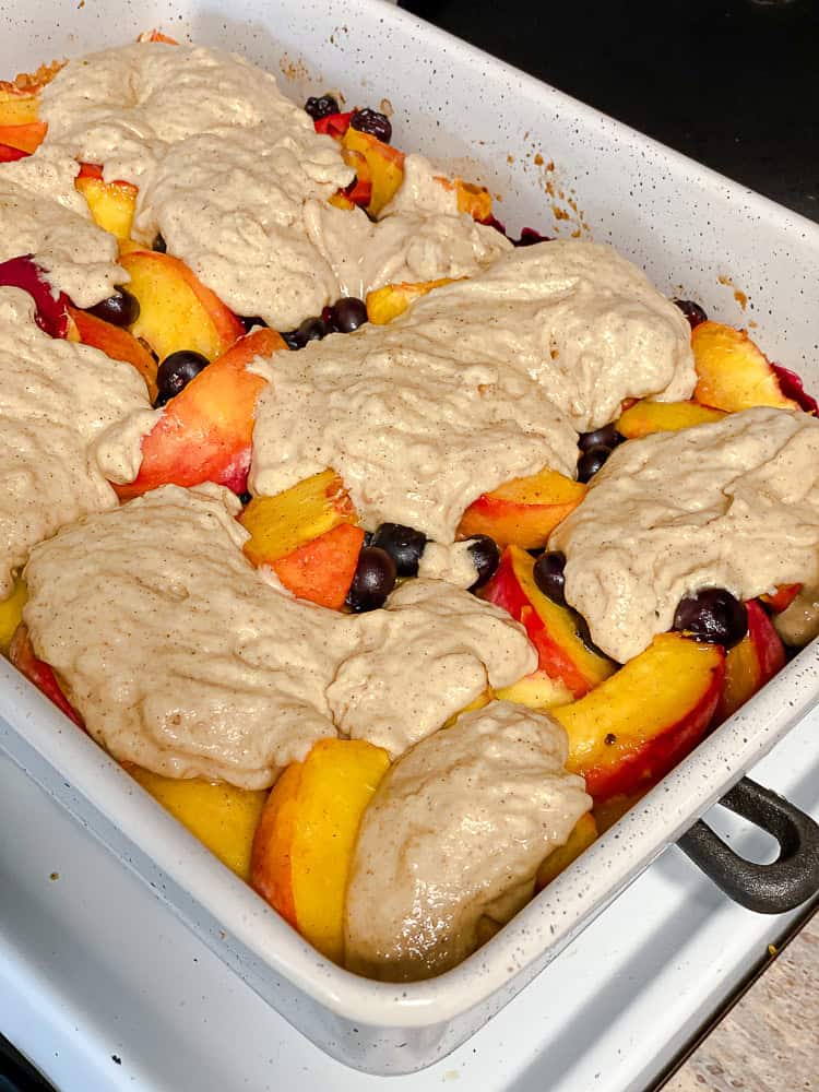 process shot showing unbaked cobbler in pan