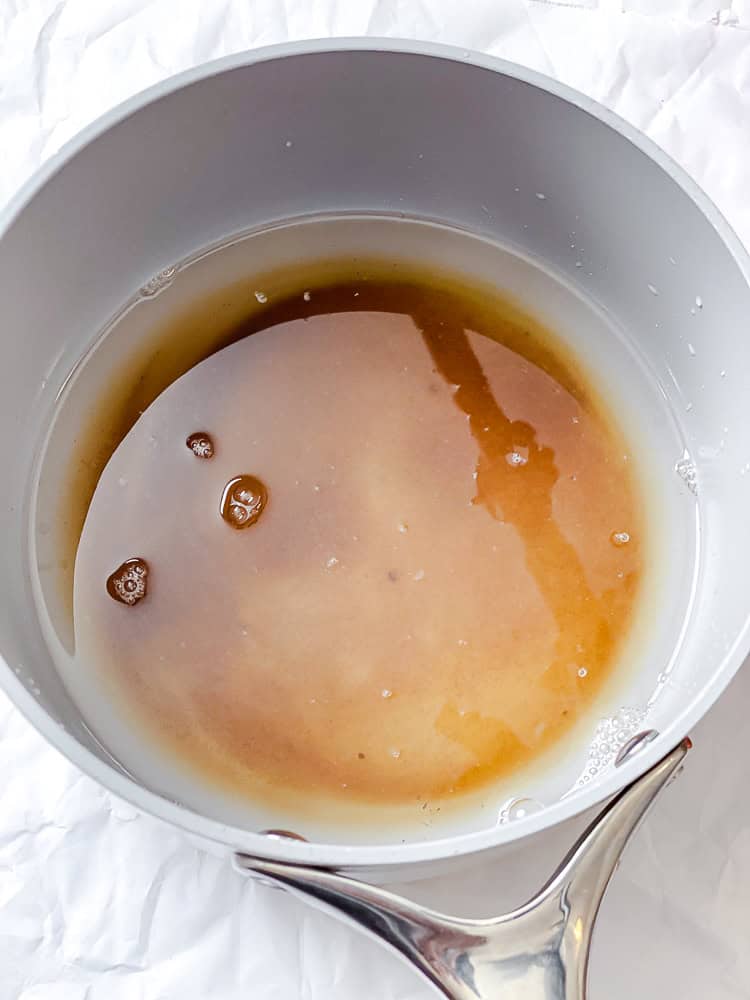 ingredients for vanilla simple syrup in a grey saucepan.